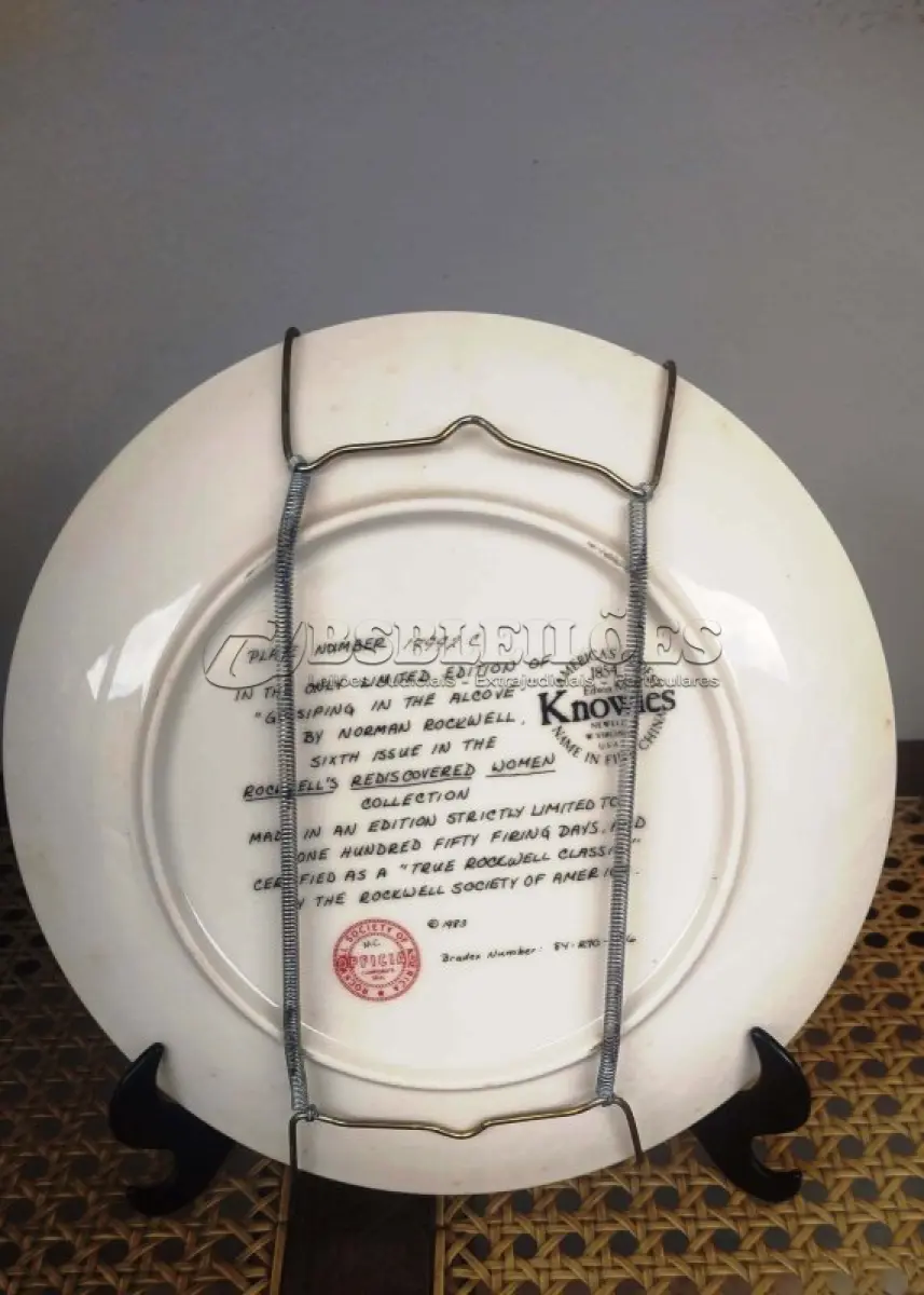 LOTE 248 - 01 PRATO DE COLECIONADOR NORMAN ROCKWELL DE 1983, FABRICADO PELA KNOWLES, A MARCA MAIS ANTIGA DA AMÉRICA EM PORCELANA FINA, FUNDADA EM 1854. ESTE PRATO É O NÚMERO 17992C  DA ÚNICA EDIÇÃO LIMITADA DE "GOSSIPING IN THE ALCOVE", DE NORMAN ROCKWELL, COM 21 CM DE DIÂMETRO SEXTA EDIÇÃO DA COLEÇÃO ROCKWELL'S REDISCOVERED WOMEN, COM SELO DE AUTENTICIDADE E CERTIFICADOS E DOCUMENTOS DO MESMO DATA DA COMPRA EM 03/031/983 FEITA EM UMA EDIÇÃO ESTRITAMENTE LIMITADA A CENTO E CINQUENTA DIAS DE QUEIMA E CERTIFICADA COMO UM "VERDADEIRO CLÁSSICO ROCKWELL" PELA ROCKWELL SOCIETY OF AMERICA. NÚMERO BRADEX: 84-R70-4.6. ITEM COMPRADO E GARAGENS DE ANTIGUIDADES NOS EUA. SUPORTE PARA PRATO NÃO INCLUÍDO NESTA VENDA. (NO ESTADO) ATENÇÃO! FAZER A VISITAÇÃO ANTES DE ARREMATAR, NÃO SABEMOS SE FUNCIONA, LEILÃO NÃO TEM GARANTIA E NEM DEVOLUÇÃO, SUJEITO A POSSÍVEIS AVARIAS VISÍVEIS/OCULTAS E/OU AUSÊNCIA DE COMPONENTES.