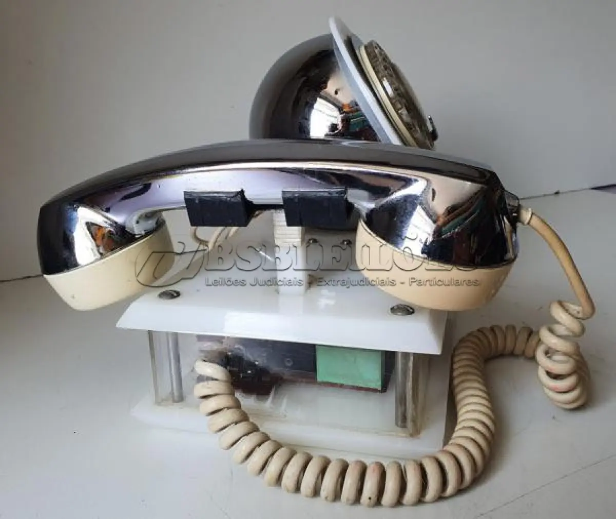 LOTE 084 - RARO TELEFONE ANOS 70. EM PLÁSTICO CROMADO E MECANISMO EM CAIXA DE ACRÍLICO MEDIDAS 24 CM COMP X 14,5 CM LARG X 19 CM ALT (NO ESTADO)