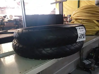 LOTE 470 - 02 PNEUS DE MOTO USADOS 100/90/19 E 90/90/21. (NO ESTADO) ATENÇÃO! FAZER A VISITAÇÃO ANTES DE ARREMATAR, NÃO SABEMOS SE FUNCIONA. LEILÃO NÃO TEM GARANTIA E NEM DEVOLUÇÃO, SUJEITO A POSSÍVEIS AVARIAS VISÍVEIS/OCULTAS E/OU AUSÊNCIA DE COMPONENTES.