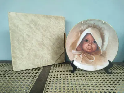 LOTE 072 - 01 PRATO COLECIONÁVEL "AMY" DE MARILYN ZAPP, DE 1983, DA BRENTWOOD FINE ARTS. ESTE PRATO FOI CRIADO A PARTIR DE UMA OBRA DE ARTE ORIGINAL DE MARILYN ZAPP. EDIÇÃO NUMERADA, 869 EXEMPLARES/12.500 SENDO LANÇADAS APENAS 10 MIL EXEMPLARES NOS EUA E 25,00EXEMPLARES LAÇADOS NO CANADA NA DÉCADA DE 80. MEDE 21,8 CM DE DIÂMETRO. SUPORTE PARA PRATO NÃO INCLUÍDO NESTA VENDA. (NO ESTADO) ATENÇÃO! FAZER A VISITAÇÃO ANTES DE ARREMATAR, NÃO SABEMOS SE FUNCIONA, LEILÃO NÃO TEM GARANTIA E NEM DEVOLUÇÃO, SUJEITO A POSSÍVEIS AVARIAS VISÍVEIS/OCULTAS E/OU AUSÊNCIA DE COMPONENTES.