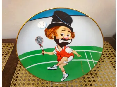 LOTE 319 - 01 RARO PRATO DE COLECIONADOR DE EDIÇÃO LIMITADA APRESENTA O ICÔNICO PERSONAGEM RED SKELETON, "ASSINADO À MÃO" FREDDIE, JOGANDO TÊNIS  "LOVE THAT FREDDIE" "EM PORTUGUES AMO ESSE FREDDIE" COM 21 CM DE DIÂMETRO, PEÇA  VINTAGE FOI FABRICADA NOS ESTADOS UNIDOS DURANTE A DÉCADA DE 1980 E ESTÁ EM EXCELENTES CONDIÇÕES. PERFEITA PARA QUALQUER ENTUSIASTA DO RED SKELETON, ITEM DE COLECIONADOR, ESTA PEÇA DECORATIVA ADICIONARÁ UM TOQUE DE HUMOR E NOSTALGIA A QUALQUER COLEÇÃO.  ITEM ÚNICO E DIFÍCIL DE ENCONTRAR, ÚNICO NO BRASIL APENAS 10 MIL PRATOS LANÇADOS NOS EUA. PRATO DE Nº 109/10.000. ITEM COMPRADO EM GARAGEM DE ANTIGUIDADES NOS EUA. SUPORTE PARA PRATO NÃO INCLUÍDO NESTA VENDA. (NO ESTADO) ATENÇÃO! FAZER A VISITAÇÃO ANTES DE ARREMATAR, NÃO SABEMOS SE FUNCIONA, LEILÃO NÃO TEM GARANTIA E NEM DEVOLUÇÃO, SUJEITO A POSSÍVEIS AVARIAS VISÍVEIS/OCULTAS E/OU AUSÊNCIA DE COMPONENTES.