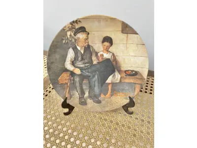01 PRATO NORMAN ROCKWELL.UM PEDAÇO DA HISTÓRIA AMERICANA COM ESTE PRATO DE COLECIONADOR DE  EDIÇÃO LIMITADA, COM UMA BELA ILUSTRAÇÃO DE NORMAN ROCKWELL DE 1979. ESTE PRATO RETRATA LIGHTHOUSE KEEPER’S DAUGHTER "A FILHA DO FAROLEIRO" E É FEITO NOS ESTADOS UNIDOS. PERFEITO PARA FÃS DA ICÔNICA OBRA DE ROCKWELL, ESTE PRATO DE COLECIONADOR É UM ITEM ESSENCIAL PARA QUALQUER COLEÇÃO. ADICIONE ESTA PEÇA DESLUMBRANTE À SUA COLEÇÃO HOJE MESMO E ADMIRE OS DETALHES COMPLEXOS E AS BELAS CORES QUE FAZEM DESTE PRATO UMA OBRA DE ARTE. COM CERTIFICADO DE AUTENTICIDADE. ITEM COMPRADO E GARAGENS DE ANTIGUIDADES NOS EUA. SUPORTE PARA PRATO NÃO INCLUÍDO NESTA VENDA. (NO ESTADO) ATENÇÃO! FAZER A VISITAÇÃO ANTES DE ARREMATAR, NÃO SABEMOS SE FUNCIONA, LEILÃO NÃO TEM GARANTIA E NEM DEVOLUÇÃO, SUJEITO A POSSÍVEIS AVARIAS VISÍVEIS/OCULTAS E/OU AUSÊNCIA DE COMPONENTES.