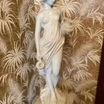 LOTE 093 - BELA ESCULTURA FEMININA EM PÓ DE MÁRMORE, AVALIADA EM 5 MIL REAIS COM BASE RICOS DETALHES. 1,52M TOTAL.  ESCULTURA: 76CM , BASE: 76CM (NO ESTADO)