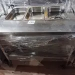 LOTE 132 - 01 BALCÃO INDUSTRIAL AQUECIDO COM PANELEIRO, 03 CUBAS E 02 PASSADORES, MEDINDO 120CMX90CM EM AÇO INOX. (NO ESTADO. LEILÃO NÃO TEM GARANTIA E NEM DEVOLUÇÃO).