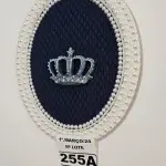 LOTE 255 - 01 QUADRO OVAL COM FUNDO EM TECIDO METALACÊ AZUL MARINHO, CORÔA DE RESINA ENVELHECIDO NO TOM AZUL E COM TOQUE PRATEADO(PINTADO À MÃO) E FINALIZADA NO VENIZ COM PÉROLAS BRANCAS (MEDIDAS: 40CMX32CM) (NOVO) (NO ESTADO)