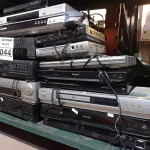 LOTE 044 - 02 VIDEOCASSETES E 12 APARELHOS DE DVD MARCAS E MODELOS DIVERSOS. (NO ESTADO) ATENÇÃO! FAZER A VISITAÇÃO ANTES DE ARREMATAR, NÃO SABEMOS SE FUNCIONA. LEILÃO NÃO TEM GARANTIA E NEM DEVOLUÇÃO, SUJEITO A POSSÍVEIS AVARIAS VISÍVEIS/OCULTAS E/OU AUSÊNCIA DE COMPONENTES.