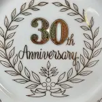 01 PRATO COMEMORAÇÃO DE ANIVERSÁRIO 30 ANOS COM 19 CM DE DIÂMETRO  BORDAS A BANHO A OURO IMPORTADO JAPÃO, SUPORTE DO PRATO NÃO ESTÁ INCLUÍDO. ITEM COMPRADO EM GARAGENS DE ANTIGUIDADES NOS EUA. (NO ESTADO) ATENÇÃO! FAZER A VISITAÇÃO ANTES DE ARREMATAR, NÃO SABEMOS SE FUNCIONA, LEILÃO NÃO TEM GARANTIA E NEM DEVOLUÇÃO, SUJEITO A POSSÍVEIS AVARIAS VISÍVEIS/OCULTAS E/OU AUSÊNCIA DE COMPONENTES.